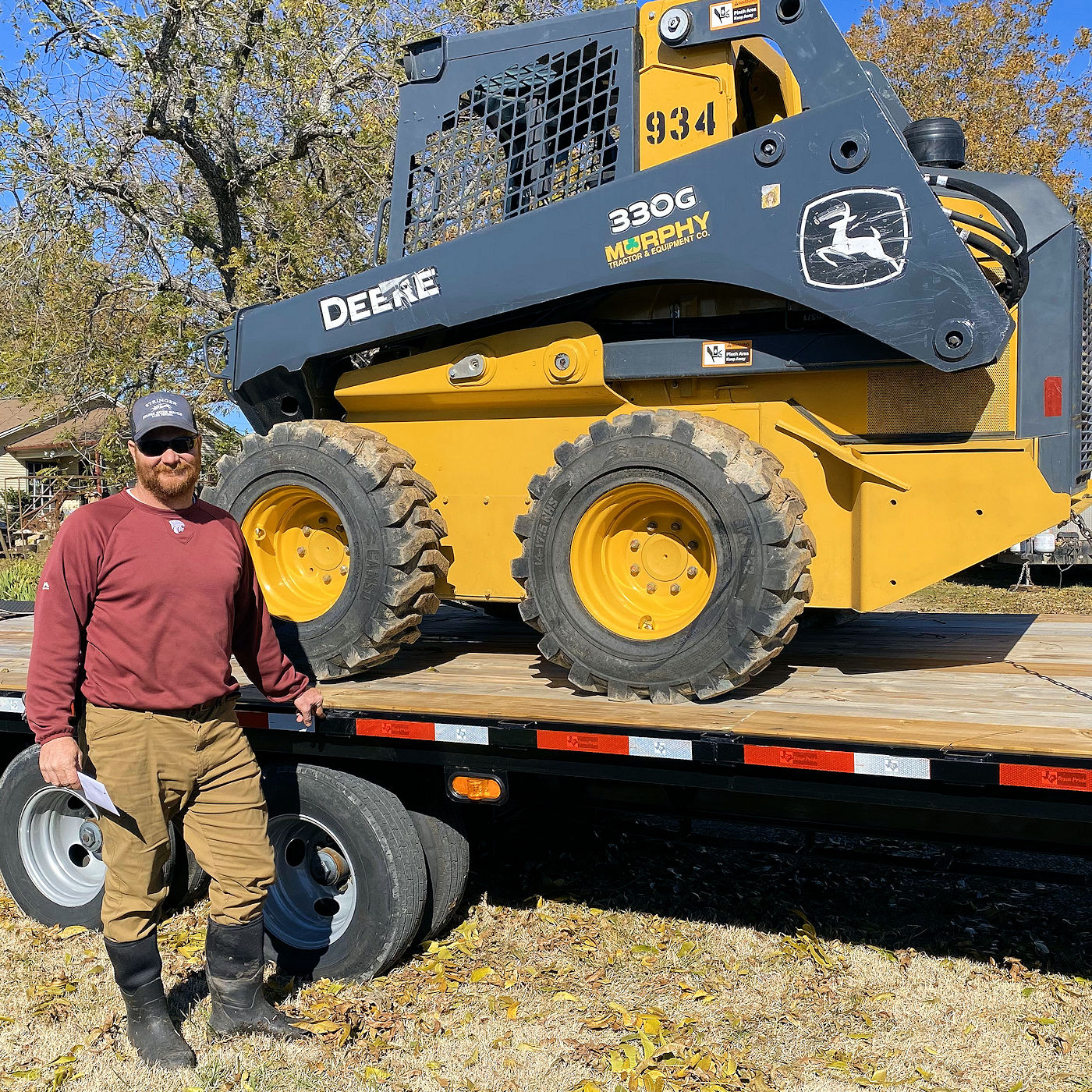 Texoma Excavation & Construction owner Zach Sanders with his Skidsteer.