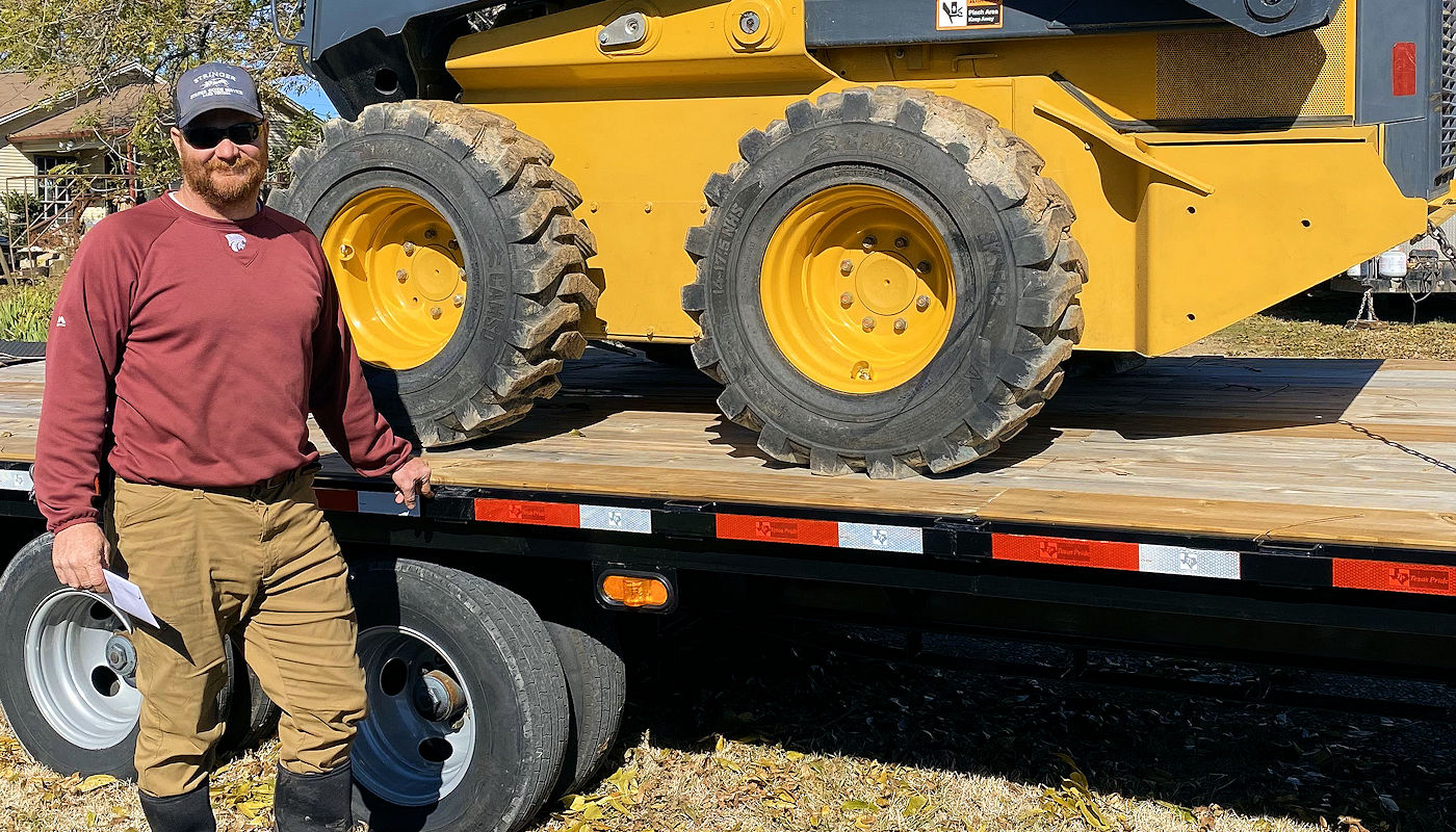 Texoma Excavation & Construction owner Zach Sanders with his Skidsteer.