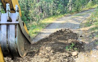 Building Gravel Roads: Cutting Water Bars Before Gravel - Texoma Excavation & Construction